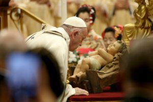 VATICAN CITY, VATICAN – DECEMBER 24: Pope Francis  kisses a figurine of Baby Jesus  as he celebrates the Christmas Eve Mass in St. Peter’s Basilica on December 24, 2019 in Vatican City, Vatican. (Photo by Franco Origlia/Getty Images)