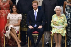 FILE – In this Tuesday, June 26, 2018 file photo Britain’s Queen Elizabeth, Prince Harry and Meghan, Duchess of Sussex pose for a group photo at the Queen’s Young Leaders Awards Ceremony at Buckingham Palace in London. In a stunning declaration, Britain’s Prince Harry and his wife, Meghan, said they are planning "to step back" as senior members of the royal family and "work to become financially independent." A statement issued by the couple Wednesday, Jan. 8, 2020 also said they intend to "balance" their time between the U.K. and North America. (John Stillwell/Pool Photo via AP, File)
