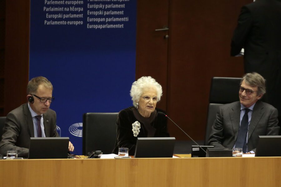 Liliana Segre, senator for life, Senato della Repubblica and survivor of Auschwitz, center, speaks during a ceremony to remember victims of the Holocaust at the European Parliament in Brussels, Wednesday, Jan. 29, 2020. (AP Photo/Virginia Mayo)