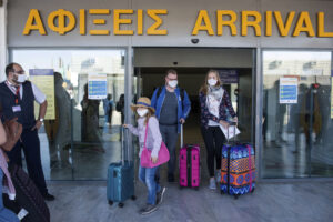 Tourists, arrive at Nikos Kazatzakis International Airport in Heraklion, Crete island, Greece, on Wednesday, July 1, 2020. The passengers most of them from Germany who came from Hamburg, with the first international flight to arrive in the island. Regional airports across Greece, including their tourist destination islands, began accepting direct international flights again on Wednesday, for the first time since flights were banned as part of the country’s lockdown to prevent the spread of the coronavirus. (AP Photo/ Harry Nakos )