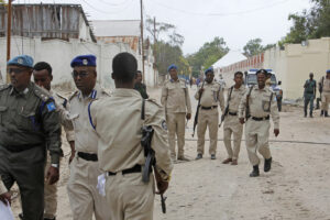 Somali police attend the scene where a suicide car bomber detonated near the gates of the motor vehicle imports duty authority headquarters near the port in Mogadishu, Somalia Saturday, July 4, 2020. Explosions rocked two of Somalia’s largest cities on Saturday as officials said a suicide car bomber detonated near the port in Mogadishu and a land mine was detonated by remote control as people were dining in a restaurant on the outskirts of Baidoa. (AP Photo/Farah Abdi Warsameh)