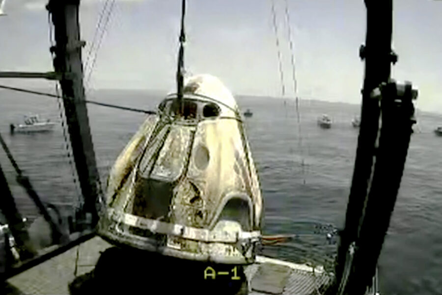 In this frame grab from NASA TV, the SpaceX capsule is lifted onto a ship, Sunday, Aug. 2, 2020 in the Gulf of Mexico. Astronauts Doug Hurley and Bob Behnken spent a little over two months on the International Space Station. It will mark the first splashdown in 45 years for NASA astronauts and the first time a private company has ferried people from orbit. (NASA TV via AP)