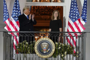 President Donald Trump and Amy Coney Barrett stand on the Blue Room Balcony after Supreme Court Justice Clarence Thomas administered the Constitutional Oath to her on the South Lawn of the White House White House in Washington, Monday, Oct. 26, 2020. Barrett was confirmed to be a Supreme Court justice by the Senate earlier in the evening. (AP Photo/Alex Brandon)