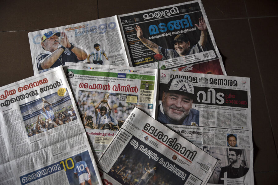 Copies of Malayalam language newspapers that have the demise of Diego Maradona as the lead news are seen in Kochi, India, Thursday, Nov. 26, 2020. Maradona, the Argentine soccer great who scored the “Hand of God” goal in 1986 and led his country to that year’s World Cup title before later struggling with cocaine use and obesity, has died. He was 60. (AP Photo/R S Iyer)