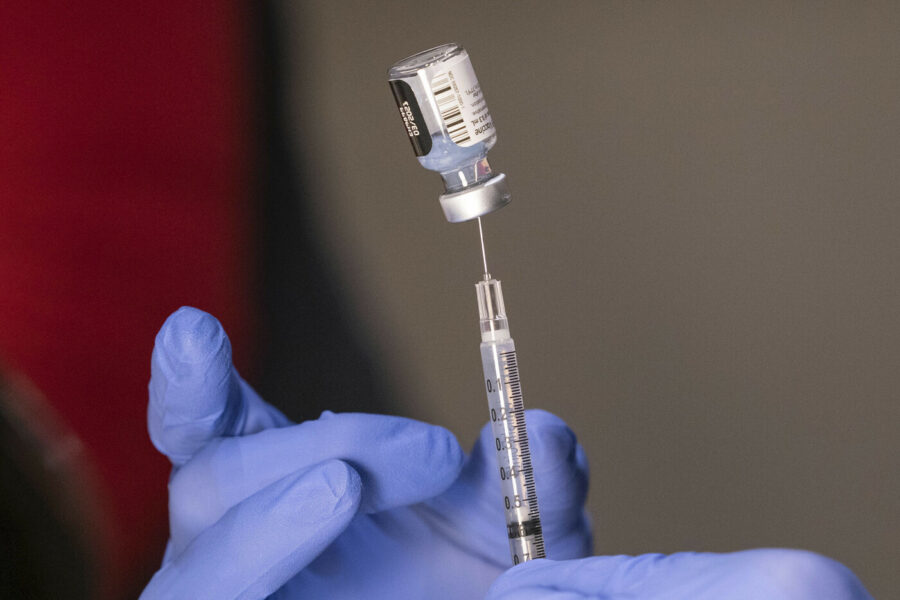 Pharmacist Ron Simono fills a syringe with a dose of the Pfizer-BioNtech COVID-19 vaccine during a vaccine clinic on Wednesday, Dec. 16, 2020, at Providence Alaska Medical Center in Anchorage, Alaska. Each glass vial contains five doses of the vaccine. The hospital, Alaska’s largest, plans to vaccinate 485 people this week. (Loren Holmes/Anchorage Daily News via AP, Pool)