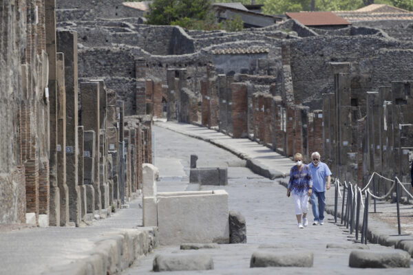 Colleen and Marvin Hewson, from the United States, visit to the archeological site of Pompeii, near Naples, southern Italy, Tuesday, May 26, 2020. The American couple waited a lifetime plus 2 ½ months to visit the ancient ruins of Pompeii together. For Colleen and Marvin Hewson, the visit to the ruins of an ancient city destroyed in A.D. 79 by a volcanic eruption was meant to be the highlight a trip to celebrate his 75th birthday and their 30th anniversary. They were among the only tourists present when the archaeological site reopened to the public on Tuesday after the national lockdown to prevent the spread of COVID-19.  (AP Photo/Alessandra Tarantino)