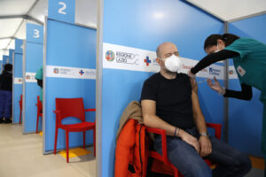 A health worker administers a dose of the AstraZeneca vaccine to a man at a vaccination center set up in Fiumicino, near Rome’s international airport, Thursday, Feb. 11, 2021. AstraZeneca is of the three vaccines authorized by the European Medicines Agency for use in the 27-nation bloc, the other two are Pfizer-BioNtech and Moderna.  (AP Photo/Alessandra Tarantino)