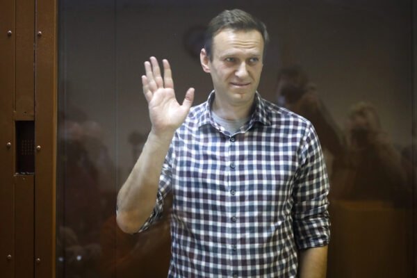 Russian opposition leader Alexei Navalny stands in a cage in the Babuskinsky District Court in Moscow, Russia, Saturday, Feb. 20, 2021. A Moscow court on Saturday considered Navalny’s appeal against his prison sentence as the country faced a top European rights court’s order to free the most prominent Kremlin foe. (AP Photo/Alexander Zemlianichenko)