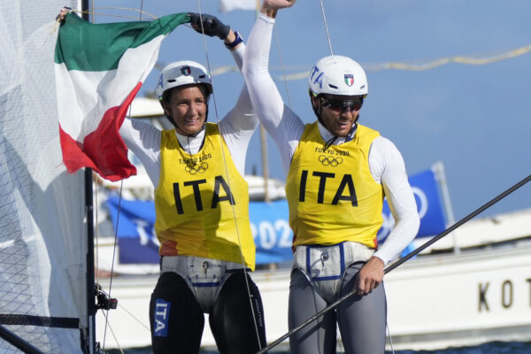 Italy’s Ruggero Tita and Caterina Banti celebrate after placing first in the mixed Nacra 17 medal race at the 2020 Summer Olympics, Tuesday, Aug. 3, 2021, in Fujisawa, Japan. (AP Photo/Bernat Armangue)