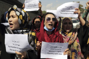 Women gather to demand their rights under the Taliban rule during a protest in Kabul, Afghanistan, Friday, Sept. 3, 2021. As the world watches intently for clues on how the Taliban will govern, their treatment of the media will be a key indicator, along with their policies toward women. When they ruled Afghanistan between 1996-2001, they enforced a harsh interpretation of Islam, barring girls and women from schools and public life, and brutally suppressing dissent. (AP Photo/Wali Sabawoon)