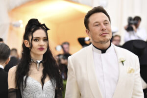 FILE – Grimes, left, and Elon Musk attend The Metropolitan Museum of Art’s Costume Institute benefit gala in New York on May 7, 2018. The Tesla and SpaceX founder tells the New York Post that he and the Canadian singer are “semi-separated.” But he says they remain on good terms, she still lives at his house in California and they continue to raise their 1-year-old son together. (Photo by Charles Sykes/Invision/AP, File)