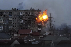 An explosion is seen in an apartment building after Russian’s army tank fires in Mariupol, Ukraine, Friday, March 11, 2022. (AP Photo/Evgeniy Maloletka)