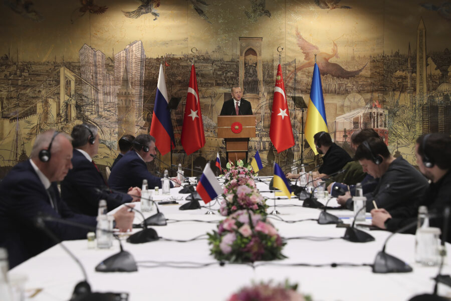 In this photo provided by Turkish Presidency, Turkish President Recep Tayyip Erdogan, center, gives a speech to welcome the Russian, left, and Ukrainian delegations ahead of their talks, in Istanbul, Turkey, Tuesday, March 29, 2022. The first face-to-face talks in two weeks between Russia and Ukraine were due to start Tuesday, raising flickering hopes of an end to a war that has ground into a bloody campaign of attrition. (Turkish Presidency via AP)