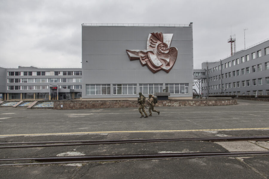 Ukrainian servicemen run at the Chernobyl nuclear plant, in Chernobyl, Ukraine, Tuesday, April 5, 2022. (AP Photo/Oleksandr Ratushniak)