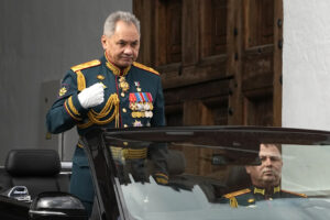 Russian Defense Minister Sergei Shoigu crosses himself as he drives to attend the Victory Day military parade in Moscow, Russia, Monday, May 9, 2022, marking the 77th anniversary of the end of World War II. (AP Photo/Alexander Zemlianichenko)