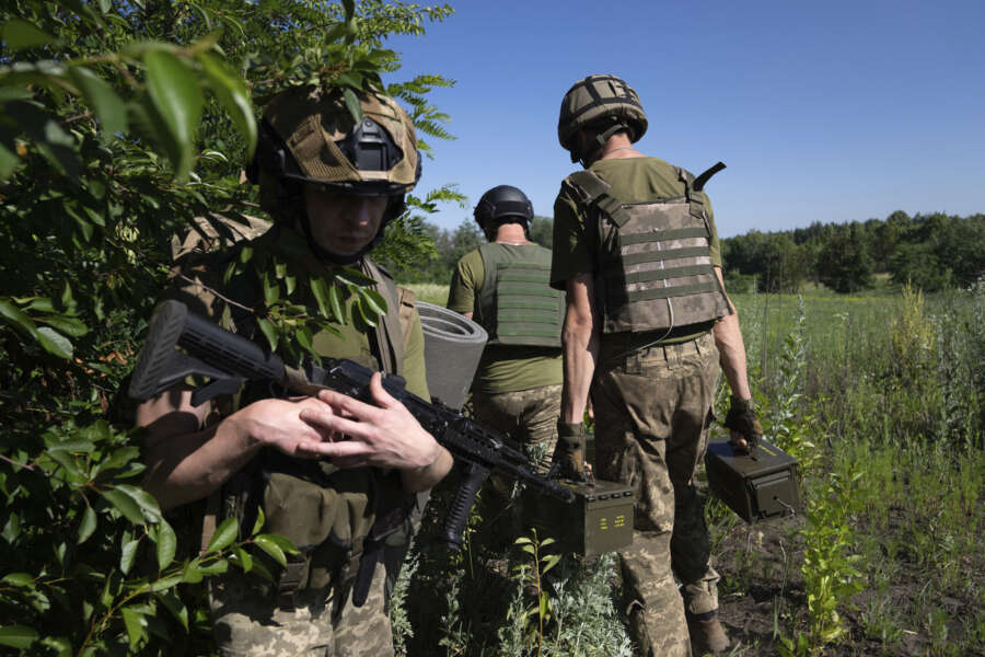 Ukrainian servicemen changing their position at the frontline near Kharkiv, Ukraine, on Saturday, July 2, 2022.(AP Photo/Evgeniy Maloletka)