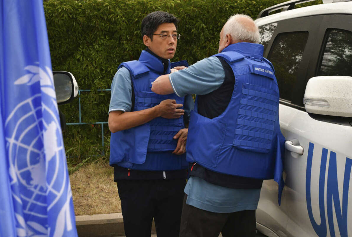 Members of mission from the U.N.’s International Atomic Energy Agency prepare to visit the Zaporizhzhia nuclear power plant in Zaporizhzhia, Ukraine, Thursday, Sept. 1, 2022. (AP Photo/Andriy Andriyenko)