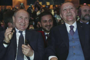 Turkish President Recep Tayyip Erdogan, right, and Russian President Vladimir Putin smile during a ceremony for the dual natural gas line, TurkStream, connecting their countries, in Istanbul, Wednesday, Jan. 8, 2020. Putin and Erdogan inaugurated the natural gas line that will open up a new export path for Russian gas into Turkey and Europe. Erdogan and Putin are also expected to discuss Syria and Libya, where the two leaders support opposing sides, while addressing regional tensions in Iraq and Iran, which have escalated with the American killing of a top Iranian commander. (Presidential Press Service via AP, Pool)