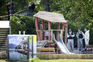 Security forces gather in a playground at the scene of knife attack in Annecy, French Alps, Thursday, June 8, 2023. An attacker with a knife stabbed several young children and at least one adult, leaving some with life-threatening injuries, in a town in the Alps on Thursday before he was arrested, authorities said. (Jean-Christophe Bott/Keystone via AP)