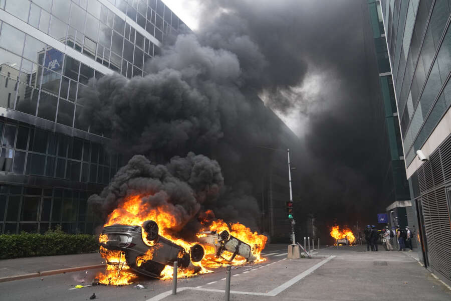 Cars burn after a march for Nahel, Thursday, June 29, 2023 in Nanterre, outside Paris. The killing of 17-year-old Nahel during a traffic check Tuesday, captured on video, shocked the country and stirred up long-simmering tensions between young people and police in housing projects and other disadvantaged neighborhoods around France. (AP Photo/Michel Euler)