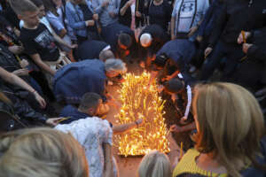 People light candles for the three killed Serbs in northern Serb-dominated part of ethnically divided town of Mitrovica, Kosovo, Tuesday, Sept.26, 2023. A Kosovo Serb party proclaimed three days of mourning starting Tuesday in Serb-dominated northern Kosovo for the three killed Serb assailants. Serbia’s president demanded Tuesday to have a NATO-led peacekeeping force take over for the national law enforcement agency in northern Kosovo after a daylong shootout between armed Serbs and Kosovar police left one officer and three gunmen dead. (AP Photo/Bojan Slavkovic)




Associated Press/LaPresse
Only Italy And Spain