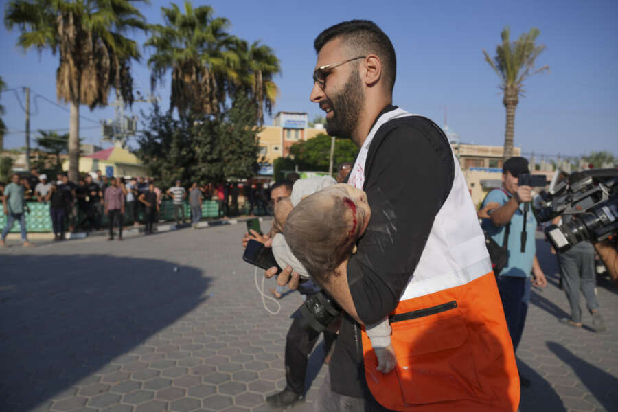 Palestinians wounded in Israeli air strikes on Gaza Strip are brought to al-Aqsa hospital in Deir el-Balah City, Gaza Strip, Saturday, Oct. 14, 2023. (AP Photo/Hatem Moussa)