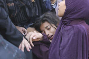 A Palestinian girl cries during the funeral of Amir Ganan, who was killed in an Israeli airstrike on the buildings in Khan Younis, Gaza Strip, Tuesday, Oct. 10, 2023. (AP Photo/Hatem Ali)