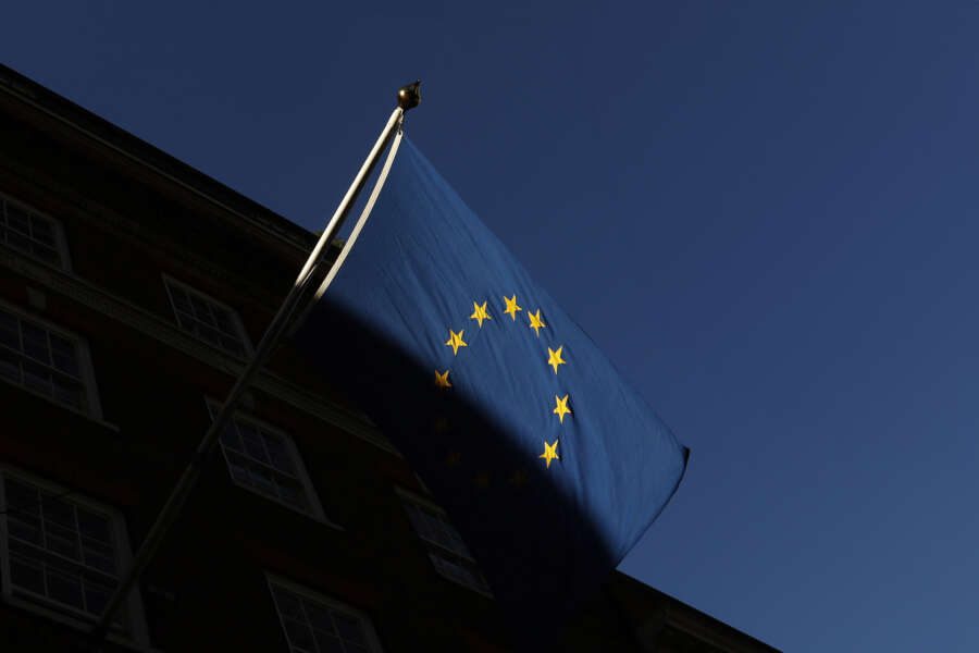 FILE – In this file photo dated Friday Jan. 22, 2021, the European Union flag flies outside Europe House in London.  Privacy campaign groups Thursday May 27, 2021, have filed a slew of legal complaints with European regulators against Clearview AI, alleging the facial recognition technology it provides to law enforcement agencies and businesses has stockpiled biometric data on more than 3 billion people without their knowledge or permission by “scraping” images from websites, breaching stringent EU privacy rules. (AP Photo/Alastair Grant, FILE)