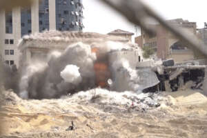 This image taken from a video released by the Israeli Defense Forces on Tuesday, Nov. 14, 2023 shows an explosion inside a building in Gaza City. The Israeli military released footage on Tuesday that it said shows joint operational activity of two army brigades in its advancement on the ground in Gaza Strip. (Israel Defense Forces via AP)