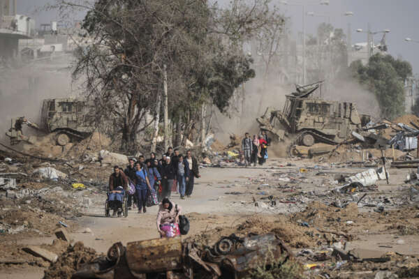 Palestinians flee south on the third day of a cease-fire between Israel and Hamas at Salah al-Din road in central Gaza Strip on Sunday, Nov. 26, 2023. (AP Photo/Hatem Moussa)