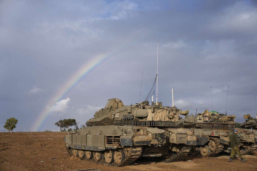 Israeli tanks are parked at an army staging area near Israel’s border with Gaza, southern Israel, Monday, Nov. 27, 2023. on the fourth day of a temporary cease-fire between Israel and Hamas. (AP Photo/Ohad Zwigenberg)