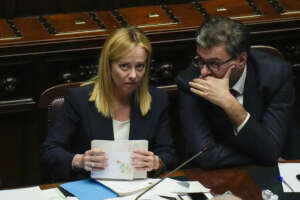 Italian Premier Giorgia Meloni, left, talks with Minister of Economy and Finance Giancarlo Giorgetti ahead of a confidence vote for her Cabinet, Tuesday, Oct. 25, 2022. AP Photo/Alessandra Tarantino)