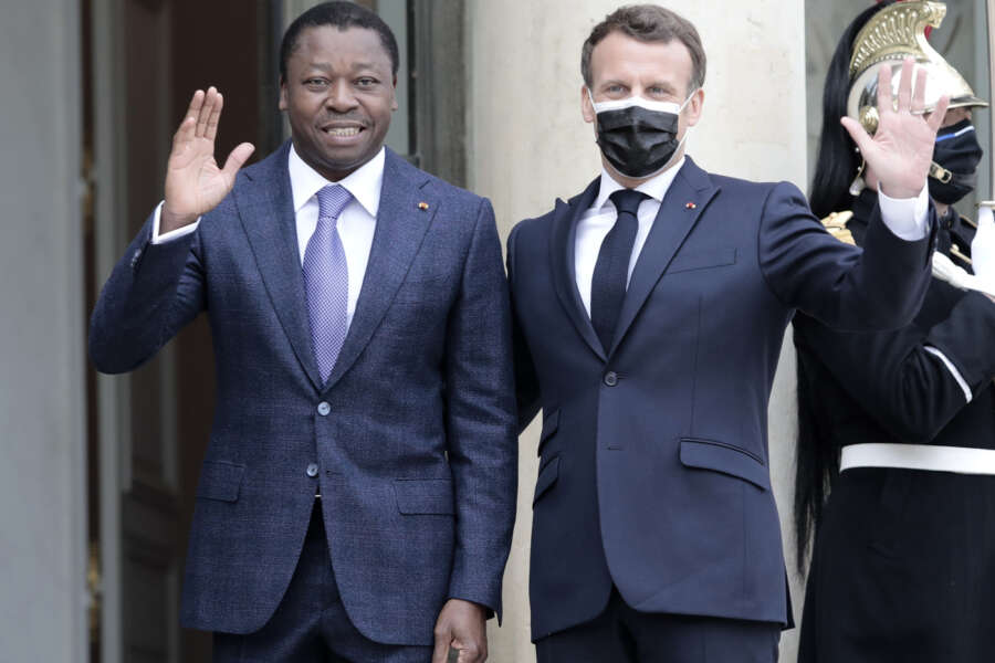 French President Emmanuel Macron, right, welcomes Togo’s President Faure Gnassingbe before a working lunch at the Elysee Palace in Paris, Friday, April 9, 2021. (AP Photo/Lewis Joly)