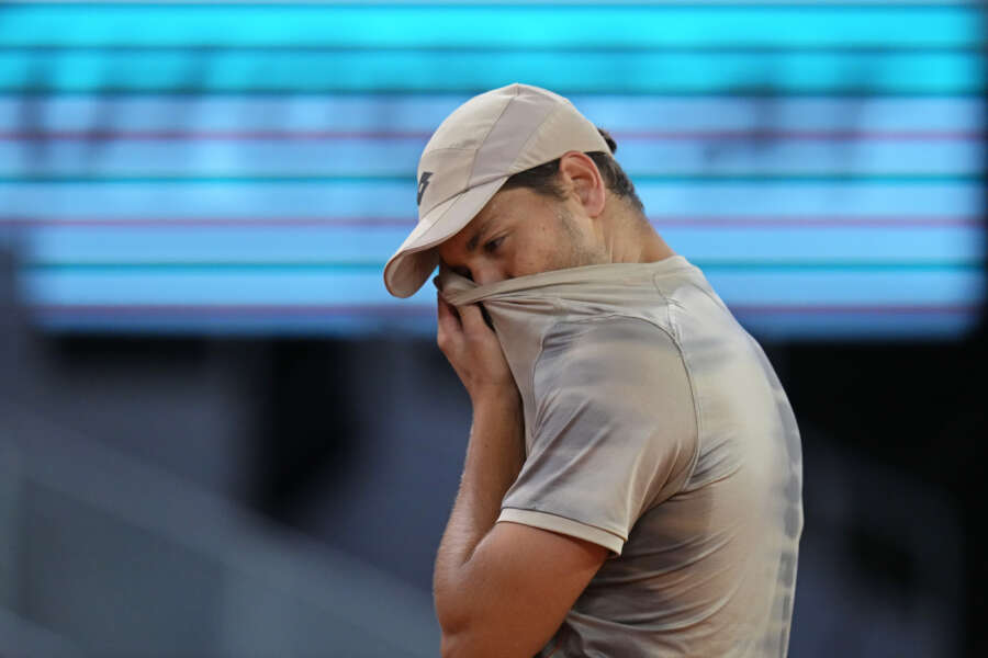 Pavel Kotov of Russia wipes his face with his shirt during the Mutua Madrid Open tennis tournament against Jannik Sinner of Italy in Madrid, Spain, Monday, April 29, 2024. (AP Photo/Manu Fernandez)