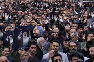 People hold up posters of Iranian President Ebrahim Raisi during a mourning ceremony for him at Vali-e-Asr square in downtown Tehran, Iran, Monday, May 20, 2024. President Raisi and the country’s foreign minister were found dead Monday hours after their helicopter crashed in fog, leaving the Islamic Republic without two key leaders as extraordinary tensions grip the wider Middle East. (AP Photo/Vahid Salemi)