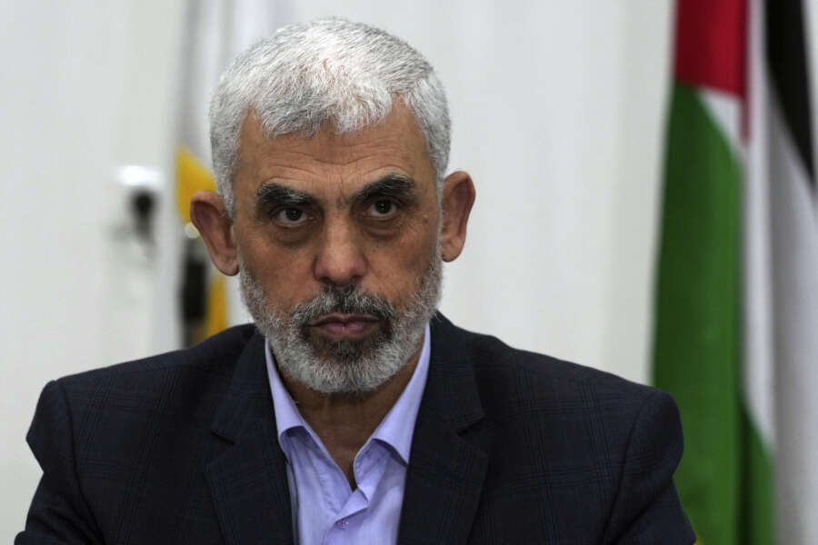FILE – Yahya Sinwar, head of Hamas in Gaza, chairs a meeting with leaders of Palestinian factions at his office in Gaza City, Wednesday, April 13, 2022. The Hamas officials are accused by the ICC of planning and instigating eight war crimes and crimes against humanity, among them extermination, murder, taking hostages, rape and torture. (AP Photo/Adel Hana, File)