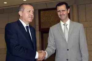 FILE – Syrian President Bashar Assad, right, shakes hands with Turkish Prime Minister Recep Tayyip Erdogan at al-Shaab presidential palace in Damascus, Syria, on Oct. 11, 2010. Erdogan and Assad have recently signaled that they are interested in restoring diplomatic ties that have been ruptured for more than a decade. (AP Photo/Bassem Tellawi, File)