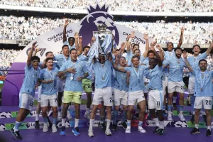 Manchester City players celebrate with the Premier League trophy after the English Premier League soccer match between Manchester City and West Ham United at the Etihad Stadium in Manchester, England, Sunday, May 19, 2024. Manchester City clinched the English Premier League on Sunday after beating West Ham in their last match of the season. (AP Photo/Dave Thompson)