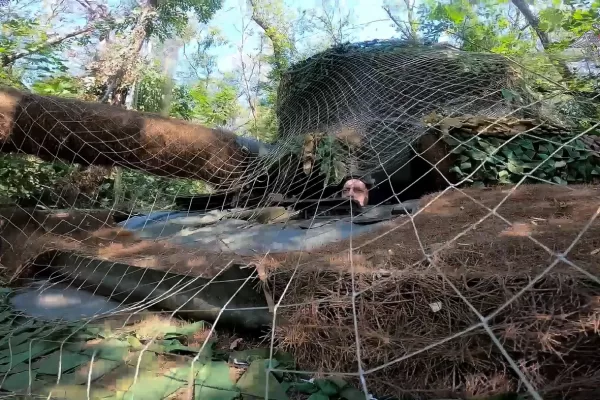 In this photo taken from video released by the Russian Defense Ministry on Sunday, Aug. 11, 2024, a Russian Army tank covered with camouflage net takes a position at an area of ​​Kursk region of Russia. (Russian Defense Ministry Press Service via AP)