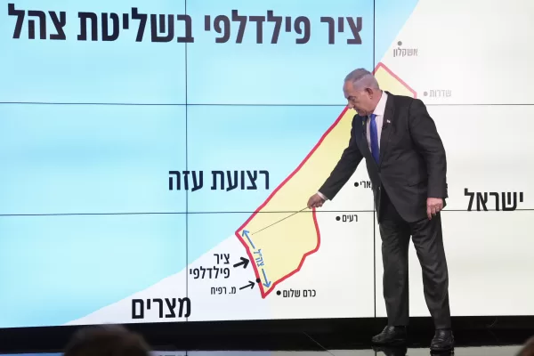 Israeli Prime Minister Benjamin Netanyahu stands before a map of the Gaza Strip, telling viewers that Israel must retain control over the "Philadelphi corridor," a strategic area along the territory’s border with Egypt, during a news conference in Jerusalem, Monday, Sept. 2, 2024. The Hebrew on the screen reads, "Philadelphi corridor under Israeli military control." (AP Photo/Ohad Zwigenberg, Pool)