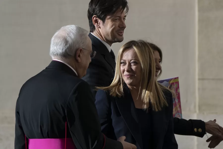 Italian Premier Giorgia Meloni, center, talks to Monsignor Leonardo Sapienza, left, as she arrives with her partner Andrea Giambruno, second from left, and her sister Arianna (partially hidden) at The Vatican, Tuesday, Jan. 10, 2023 for an audience with Pope Francis. (AP Photo/Domenico Stinellis)