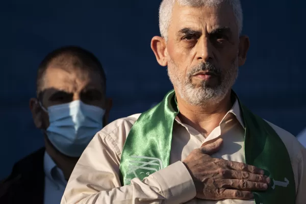 FILE – Yahya Sinwar, Palestinian leader of Hamas in the Gaza Strip, places his hand over his heart on stage after greeting supporters at a rally on May 24, 2021, in Gaza City, the Gaza Strip. (AP Photo/John Minchillo, File)