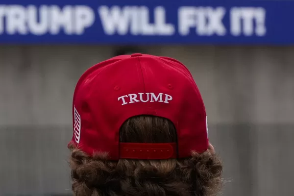 A supporter waits to enter a campaign rally for Republican presidential nominee former President Donald Trump, Sunday, Nov. 3, 2024, in Macon, Ga. (AP Photo/Mike Stewart)