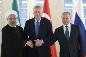 FILE – From left: Iranian President Hassan Rouhani, Turkish President Recep Tayyip Erdogan and Russian President Vladimir Putin shake hands during their meeting in Ankara, Turkey, Monday, Sept. 16, 2019. (AP Photo/Pavel Golovkin, Pool, File)