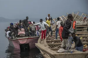 People fleeing M-23 rebel advances arrive by boat in Goma, Democratic Republic of the Congo, Wednesday, Jan. 22, 2025. (AP Photo/Moses Sawasawa)